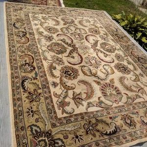 An 8 by 10 handmade tuffed rug... Made in India